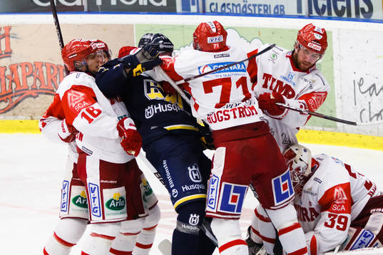 Flera Timråspelare i gruff med en av HV71:s spelare.