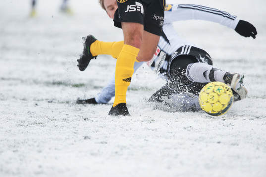 Tackling, glidtackling på halkig , snöig, konstgräsplan.