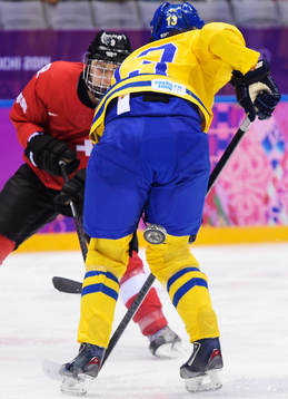 Schweiz Stefanie Marty skjuter en pucken mellan benen på