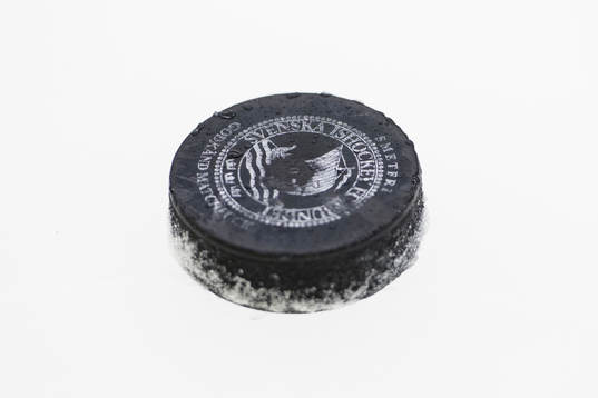 Svenska Ishockeyförbundets officiella matchpuck på isen