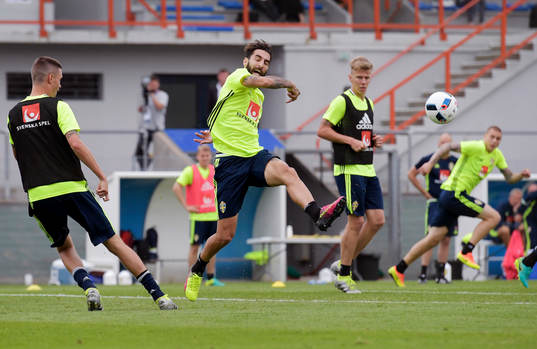Sveriges Mikael Lustig slår en boll förbi Jimmy Durmaz