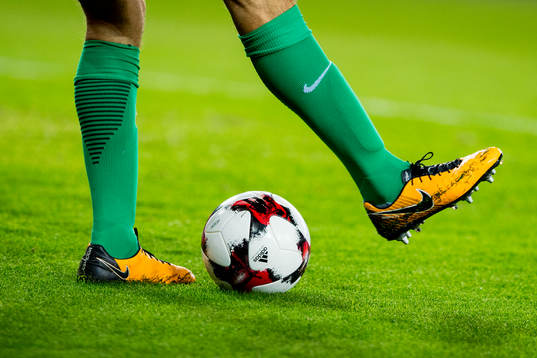 A goalkeeper with a football