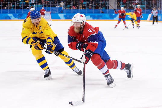 Staffan Kronwall of Sweden defends against Patrick Thoresen