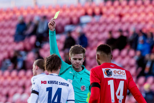 Andre Danielsen of Viking is shown a yellow card by