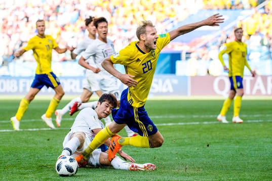 Sungyueng Ki of South Korea against Ola Toivonen of Sweden