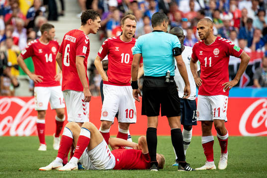 Players of Denmark talks to referee Sandro Ricci