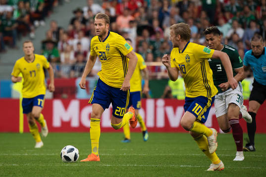 Ola Toivonen and Emil Forsberg of Sweden sprints past