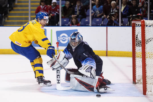 Adam Boqvist of Sweden in action against goaltender Kyle
