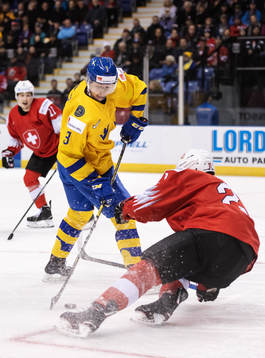 Adam Boqvist of Sweden dribbles past Tim Berni of