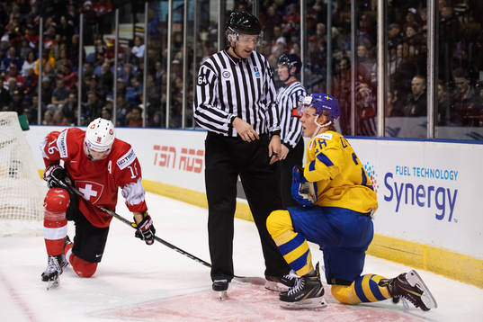 Fabian Zetterlund (R )of Sweden gets a penalty