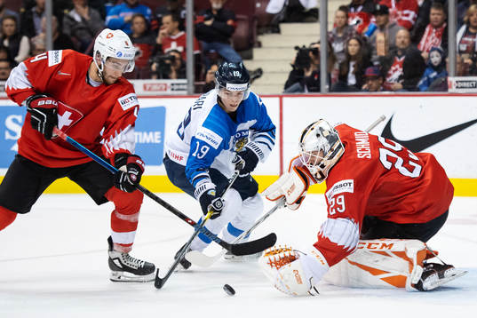 Simon le Coultre and goaltender Akira Schmid of Switzerland