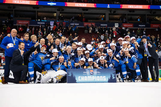 Players and coaching staff of Finland celebrate their win