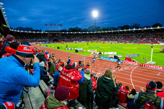 Spectators in the stand watch Dina Asher-Smith of Great