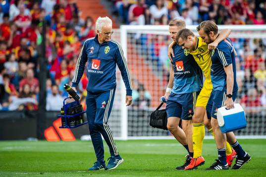 Viktor Claesson of Sweden receives help of the pitch