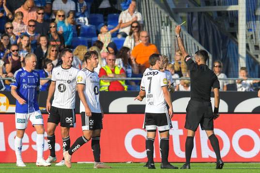 Anders Trondsen of Rosenborg receives a yellow card from