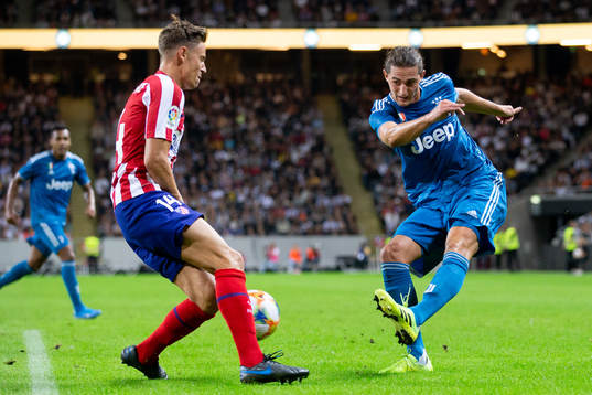 Kieran Trippier of Atletico Madrid and Adrien Rabiot of