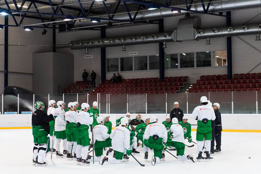 Spelare och tränare samlade på en träning med