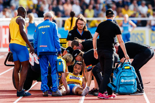 Erik Hagberg of Sweden receives medical treatment