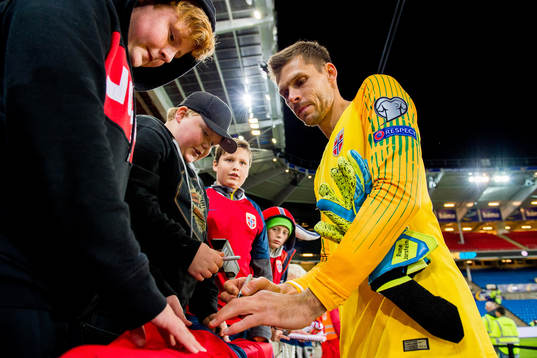 Goalkeeper Rune Almenning Jarstein of Norway signs
