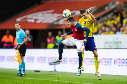 Tarik Elyounoussi of Norway and Mikael Lustig of Sweden