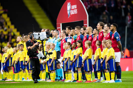 Mascots infront of the players at the line-up