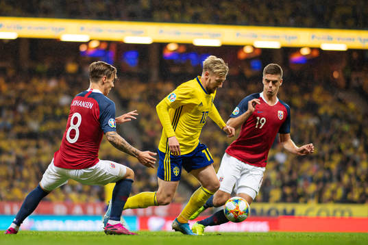Stefan Johansen and Markus Henriksen of Norway are being