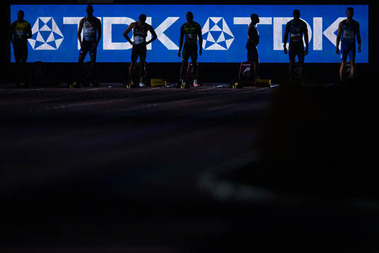 The competitors in the final of men’s 100 meter are lined