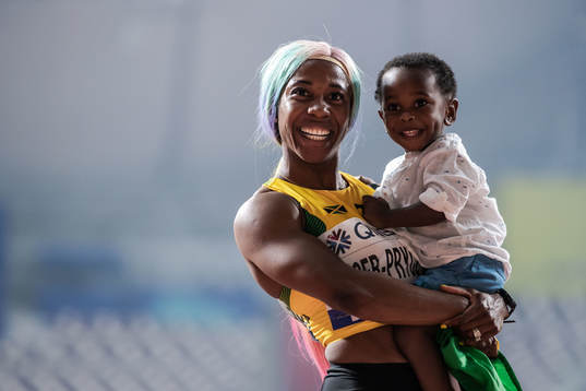 Shelly-Ann Fraser-Pryce of Jamaica celebrates with her son