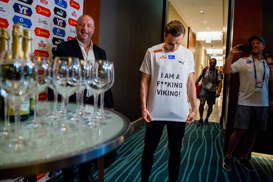 Karsten Warholm of Norway celebrates with his team, friends