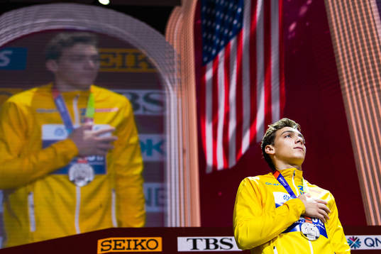 Armand Duplantis of Sweden (silver) holds a hand over his
