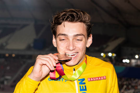 Armand Duplantis of Sweden bites his silver medal at the
