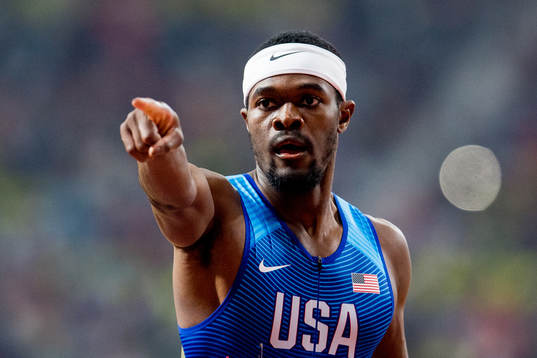 Rai Benjamin of USA celebrates crossing the finish line to