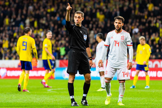 Referee Clement Turpin calls a corner kick