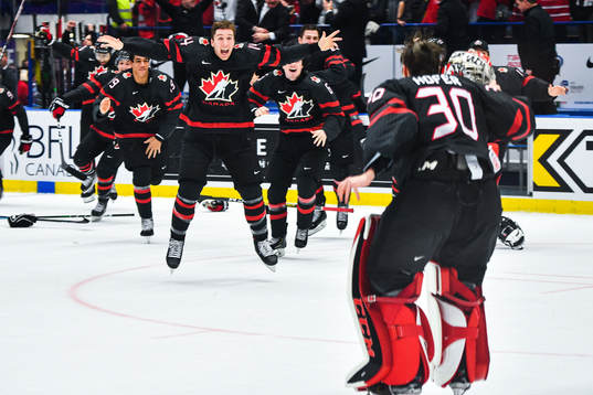 Jared McIsaac celebrate with goalkeeper Joel Hofer of Canada