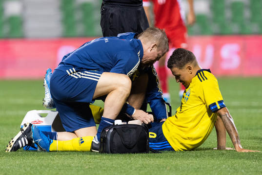 Jordan Larsson of Sweden receives medical attention