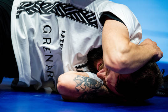 Nils Kreicsbergs of Latvia lies down with an injury