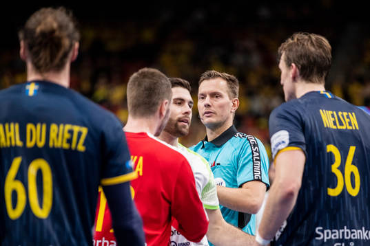 Players of Sweden in a discussion with the referee