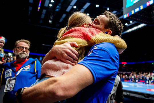 Christian Berge, head coach of Norway, hugs his daughter