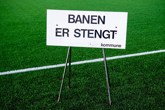 A sign states that the football field is closed as the