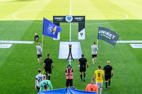 Spelarna går in på planen innan fotbollsmatchen i