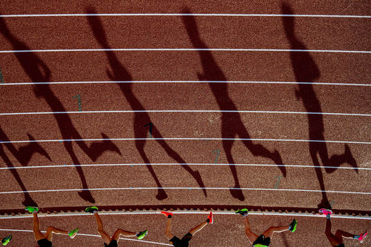 Athletes compete in the men’s 5000 meter