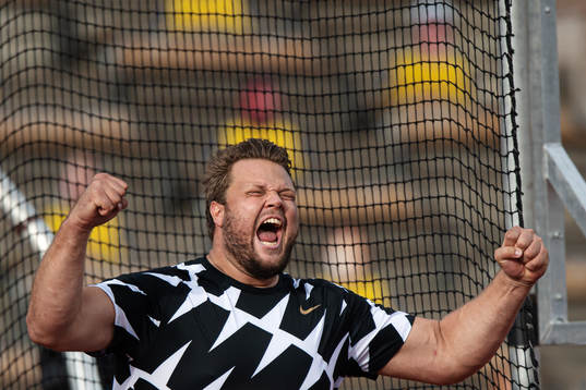 Daniel Ståhl of Sweden celebrates when competing in men's
