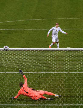 Antoine Griezmann of France misses a penalty behind