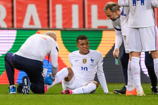 Kylian Mbappé of France receives medical attention