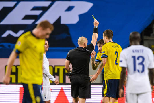 Victor Nilsson Lindelöf of Sweden receives a yellow card