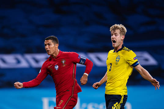 Cristiano Ronaldo of Portugal and Filip Helander of Sweden