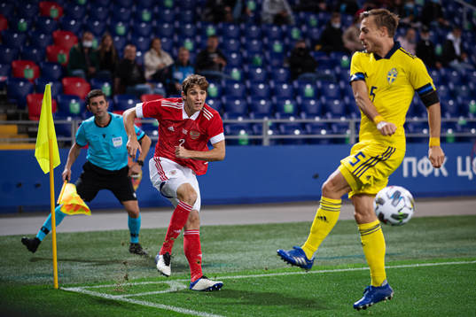 Mario Fernandes of Russia hits the ball past Pierre