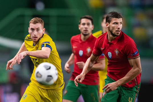 Dejan Kulusevski of Sweden and Ruben Dias of Portugal