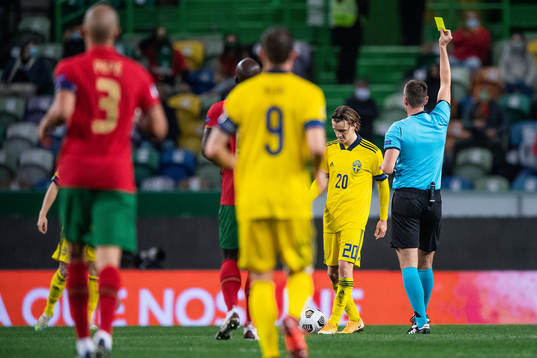 Kristoffer Olsson of Sweden receives a yellow card from