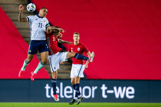 Josh Magennis of Northern Ireland and Mathias Normann of